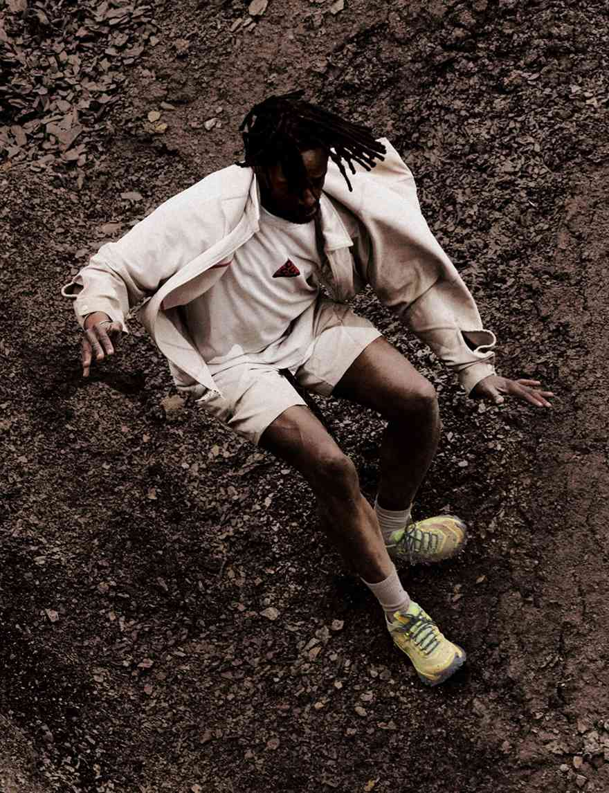 Hiker moving through dark volcanic terrain